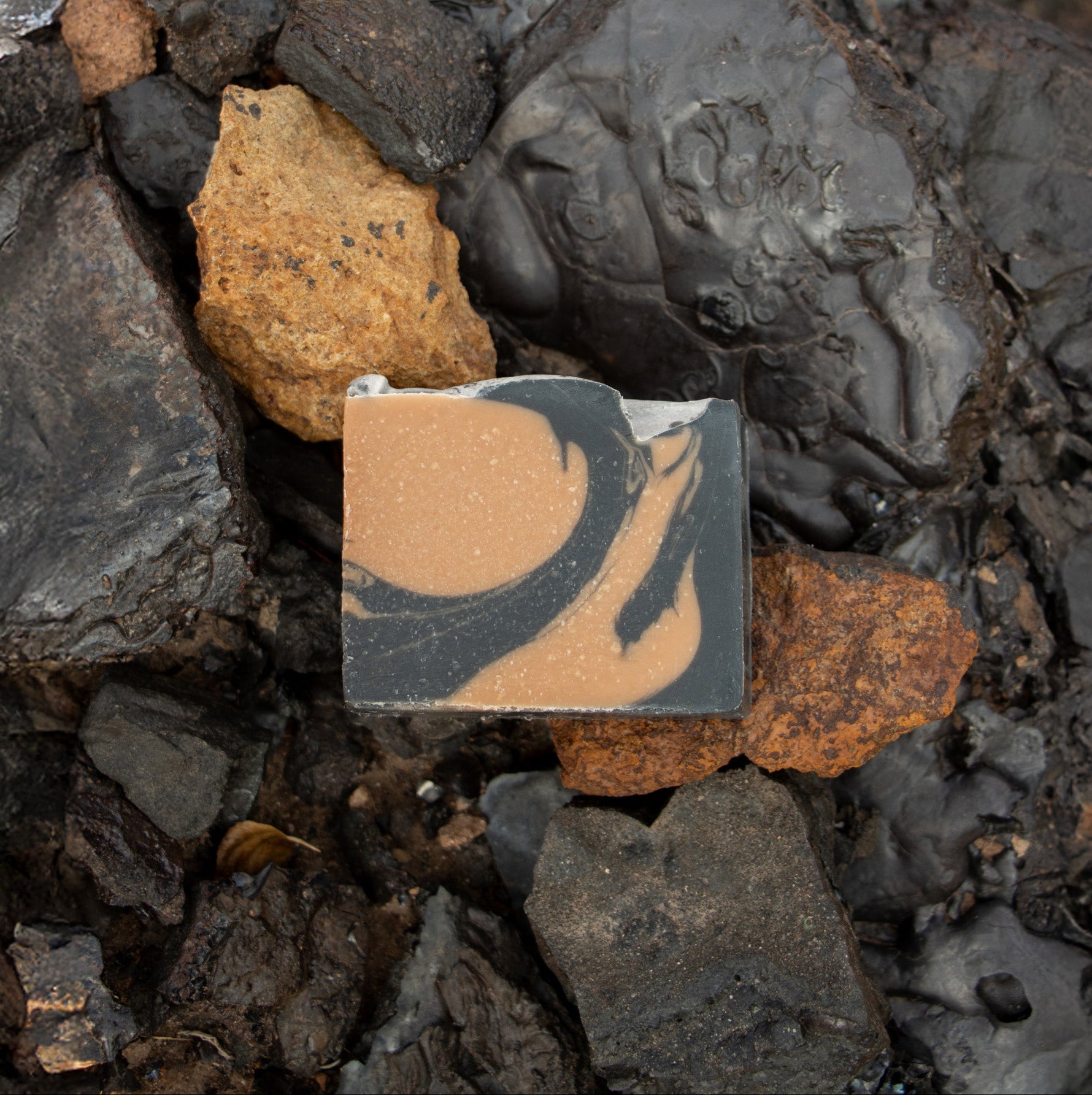 anaconda copper soap on a bed black and bronze rocks