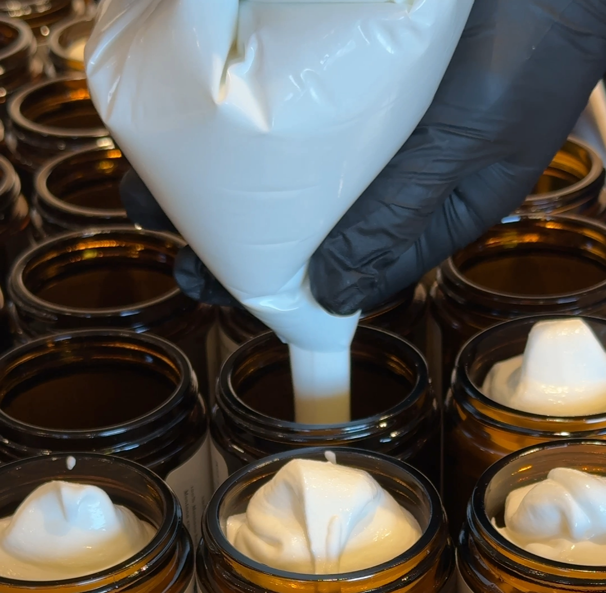 Filling jars with tallow from bag
